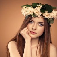 Lovely teenager girl with beautiful rose flowers in her hair